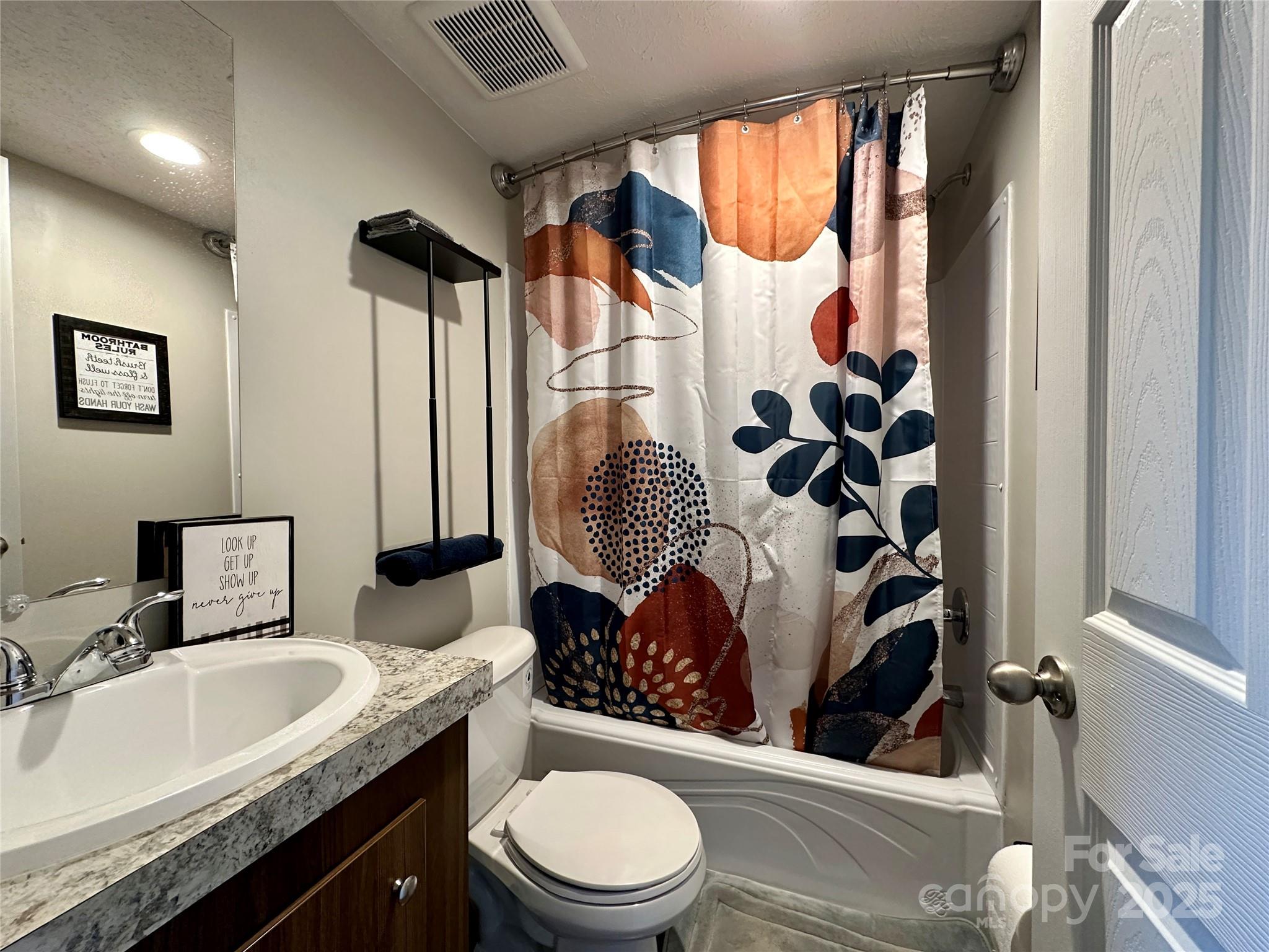 6264 Jenkins Road Morganton, NC 28655 - Photo 12 of 32 a bathroom with a granite countertop toilet sink and mirror