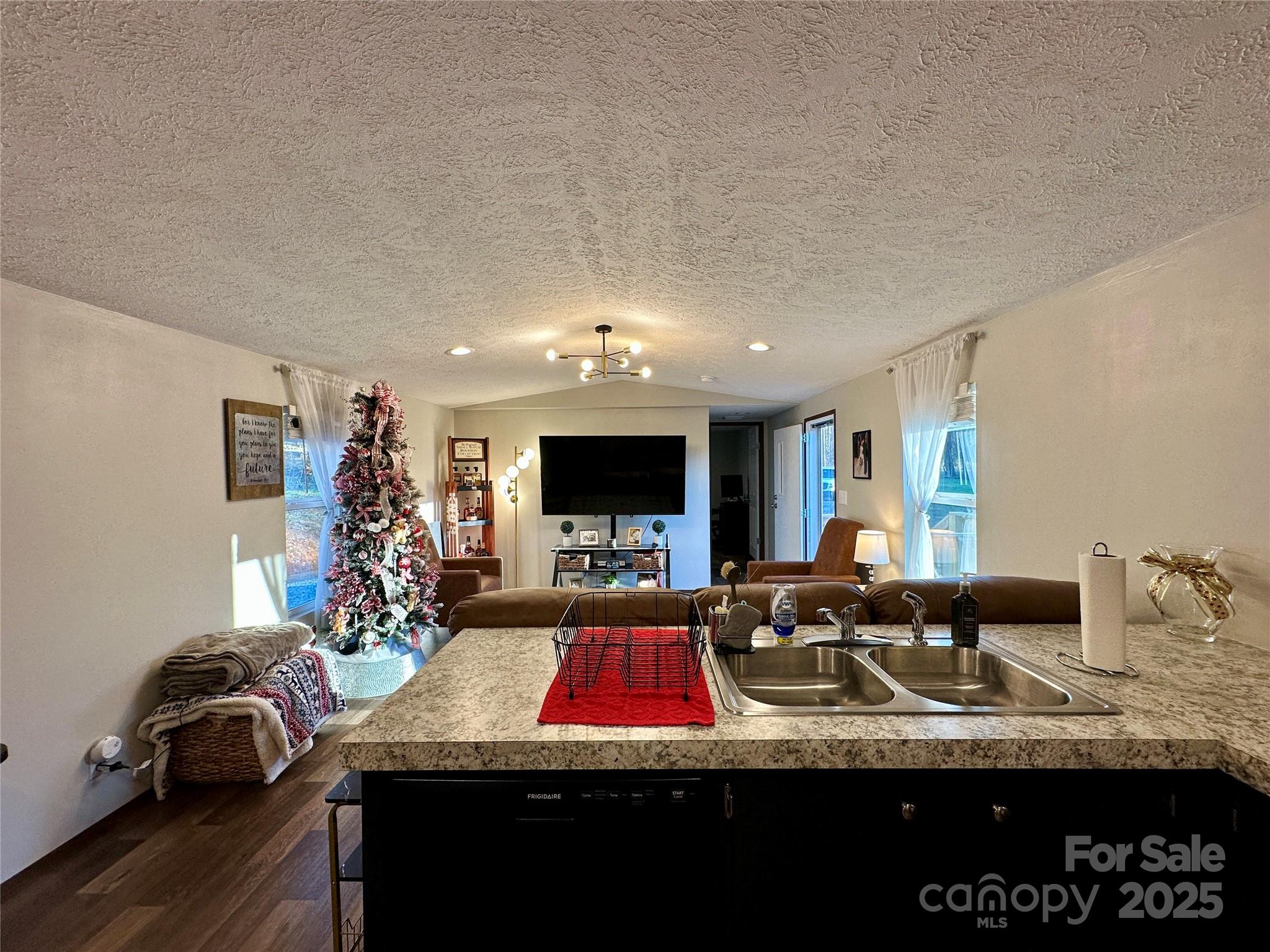 6264 Jenkins Road Morganton, NC 28655 - Photo 14 of 32 a living room with furniture a flat screen tv and a large window