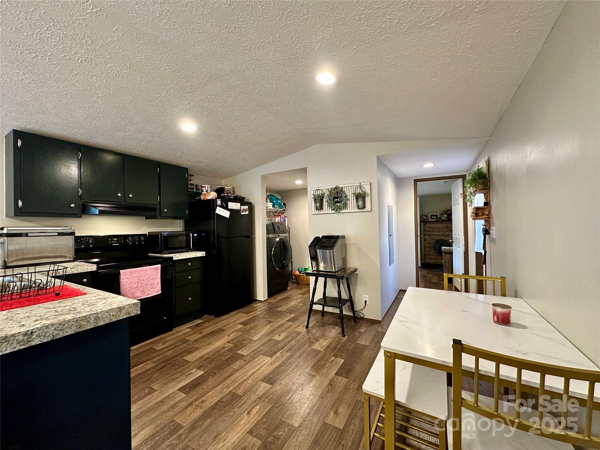 6264 Jenkins Road Morganton, NC 28655 - Photo 17 of 32 a kitchen with a table and chairs in it