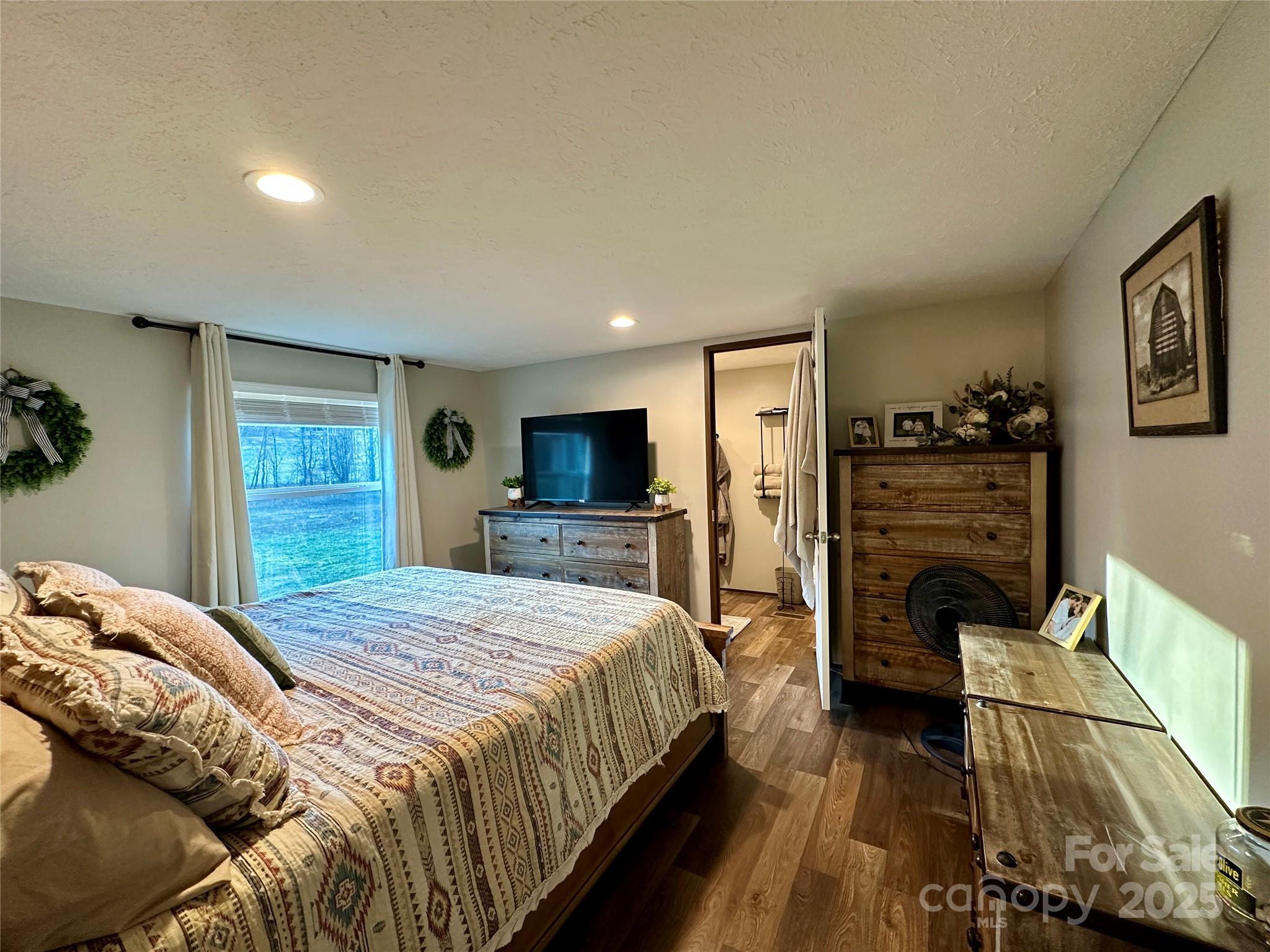 6264 Jenkins Road Morganton, NC 28655 - Photo 21 of 32 a bedroom with a bed a television and dresser