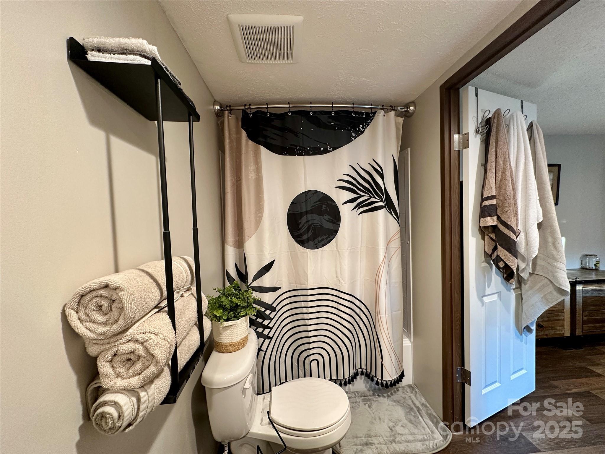 6264 Jenkins Road Morganton, NC 28655 - Photo 24 of 32 a bathroom with a toilet and a shower curtain