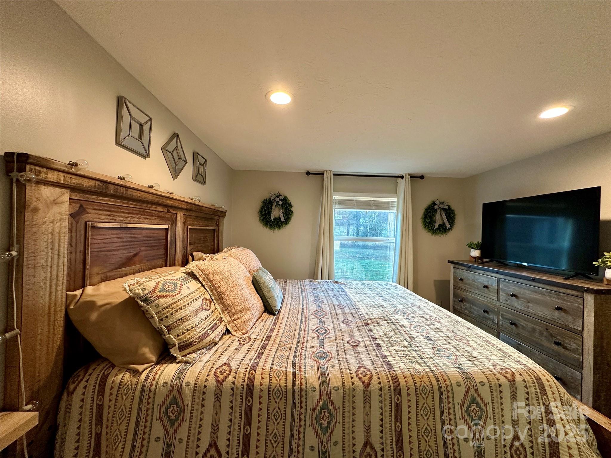6264 Jenkins Road Morganton, NC 28655 - Photo 26 of 32 a bedroom with a bed and a flat screen tv