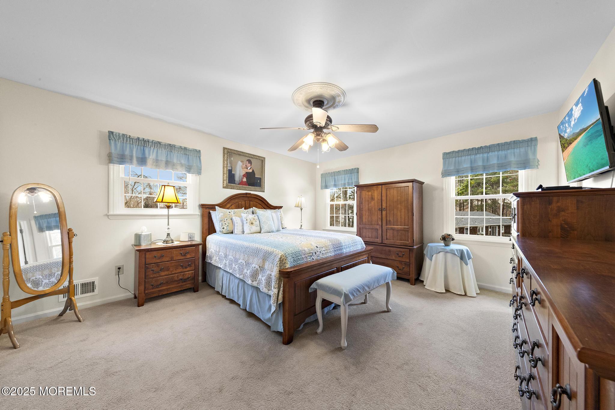 69 Chestnut Court Brick, NJ 08723 - Photo 12 of 23 a bedroom with a bed and a chandelier