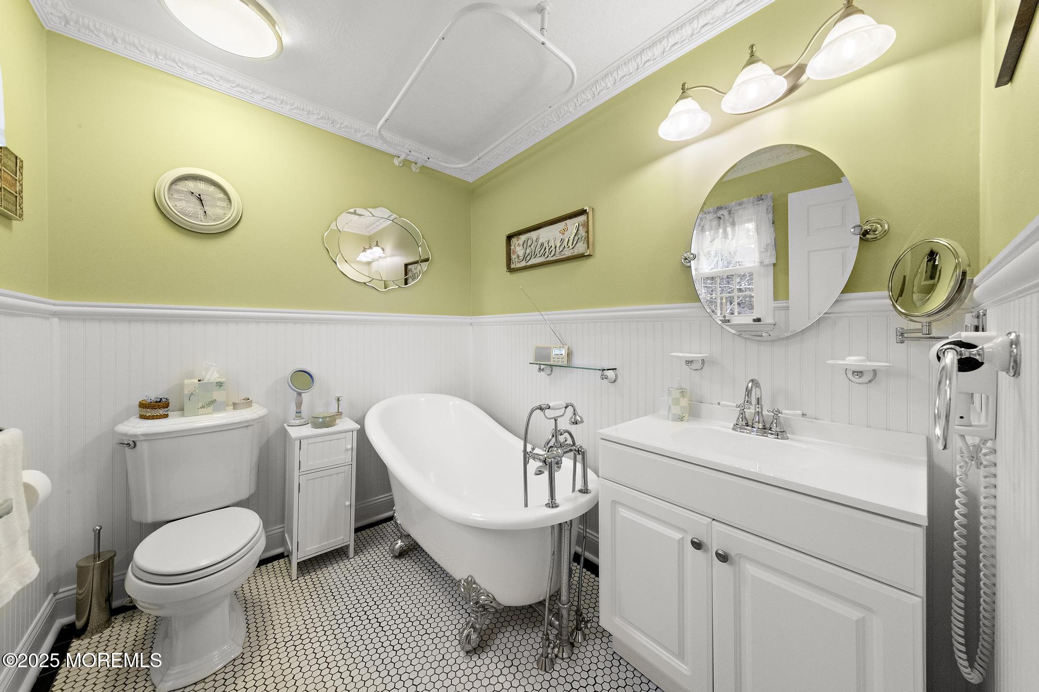 69 Chestnut Court Brick, NJ 08723 - Photo 14 of 23 a bathroom with a toilet a sink and mirror