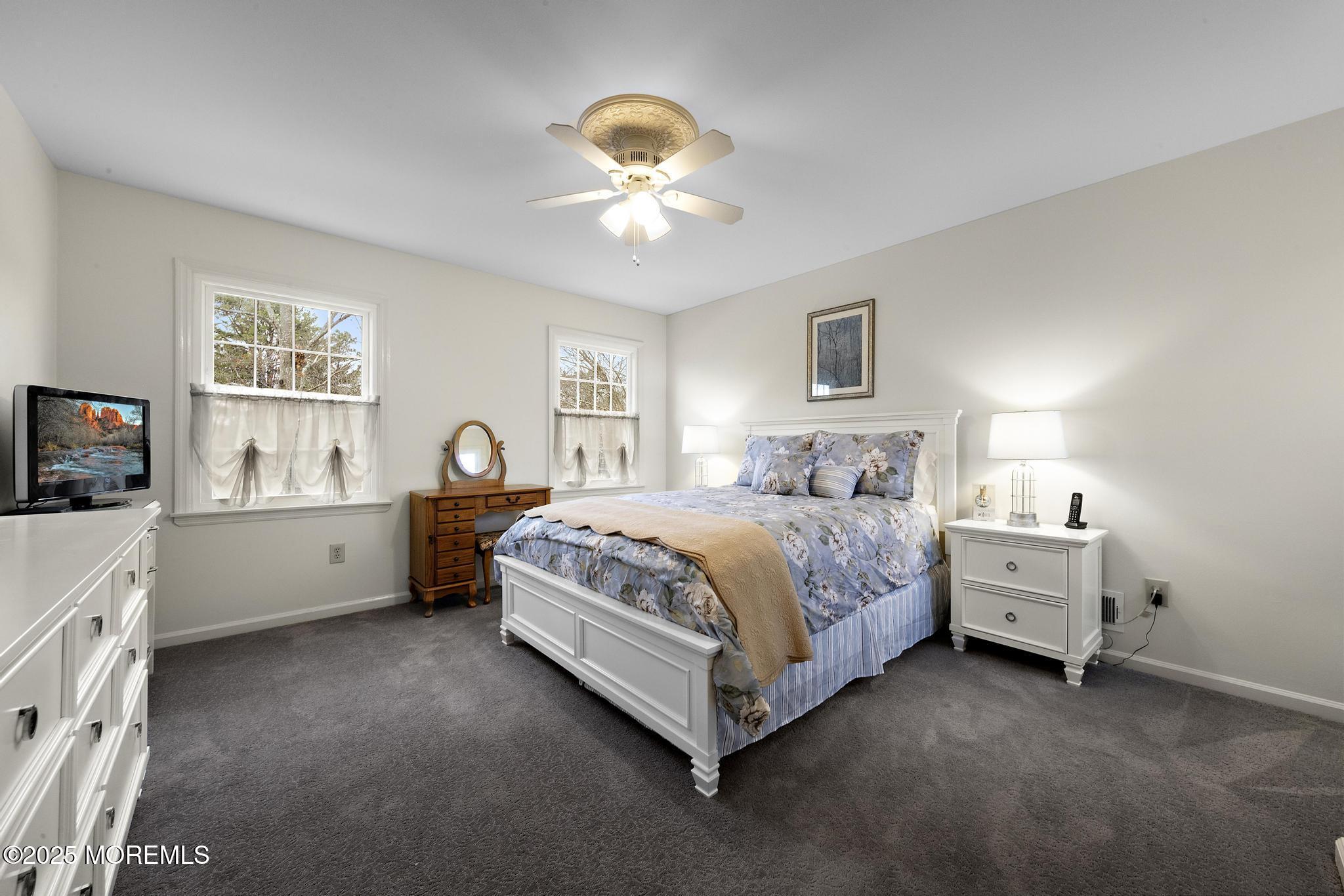 69 Chestnut Court Brick, NJ 08723 - Photo 15 of 23 a spacious bedroom with a bed and a chandelier