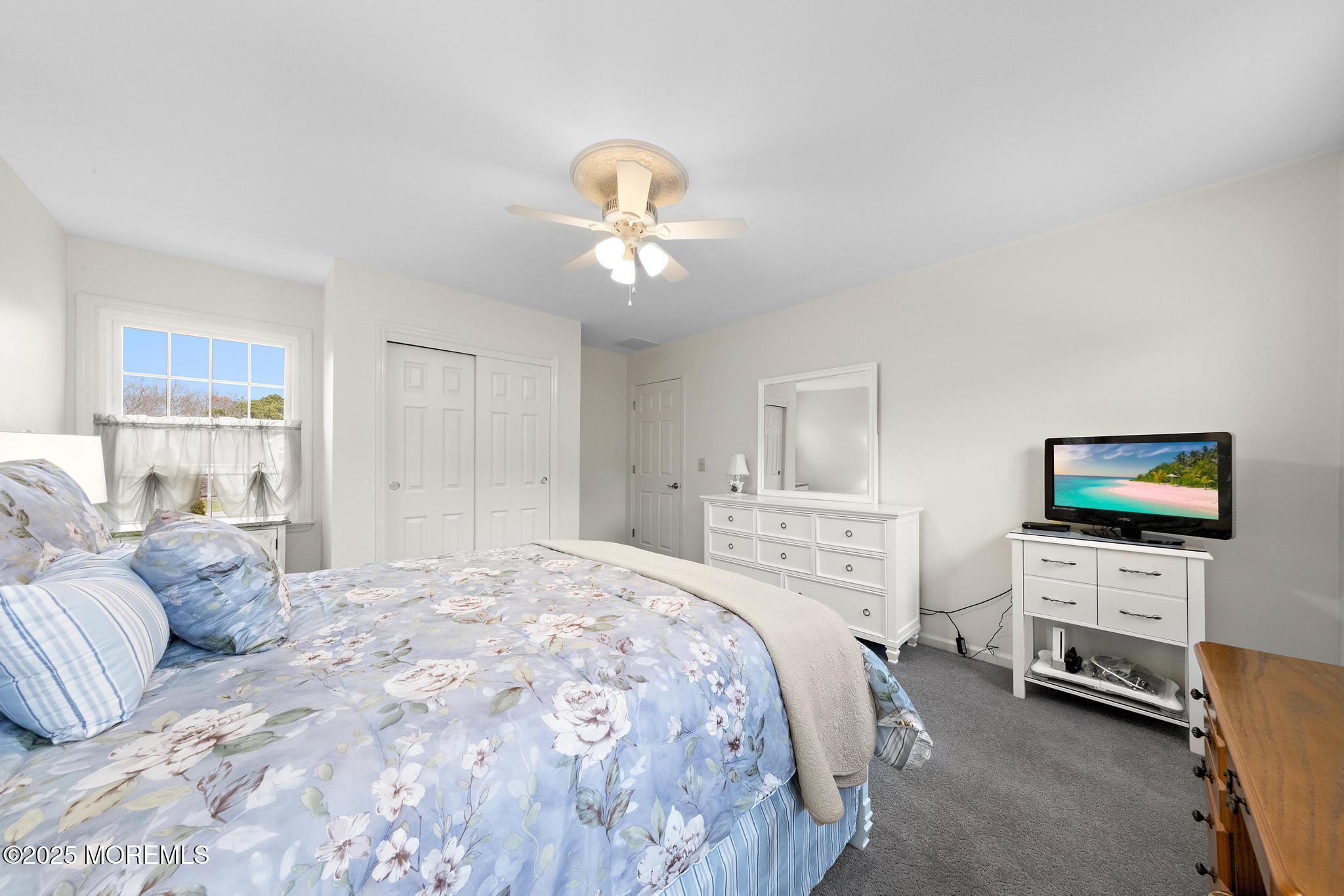 69 Chestnut Court Brick, NJ 08723 - Photo 16 of 23 a bedroom with a bed and a flat screen tv