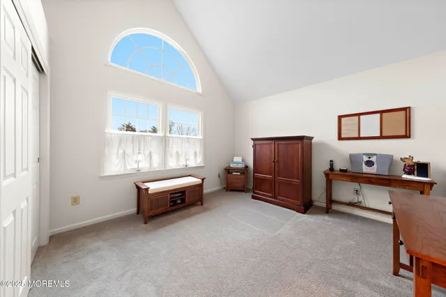 a spacious bedroom with a bed and a window