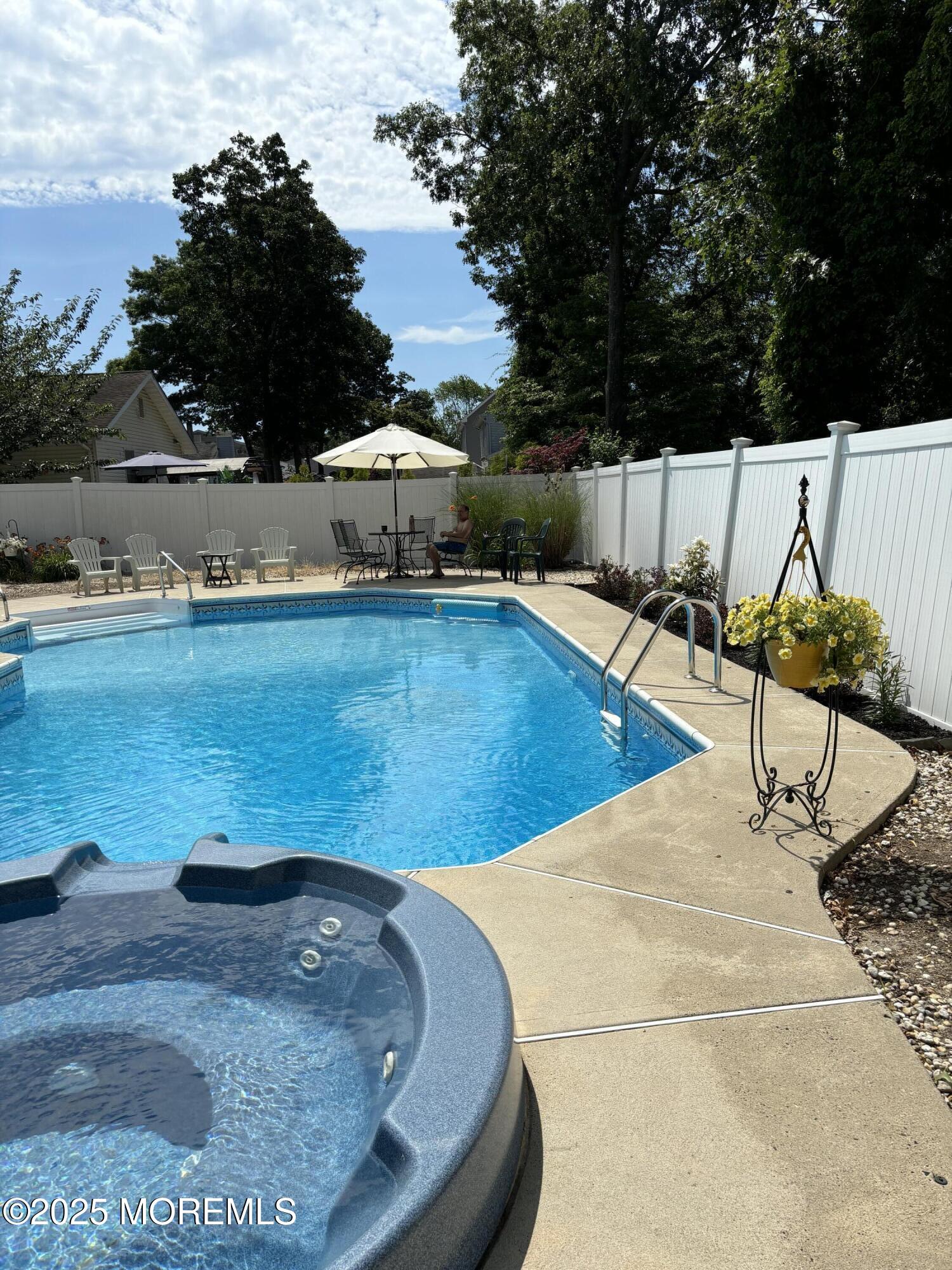 69 Chestnut Court Brick, NJ 08723 - Photo 21 of 23 a view of a swimming pool with a lounge chairs