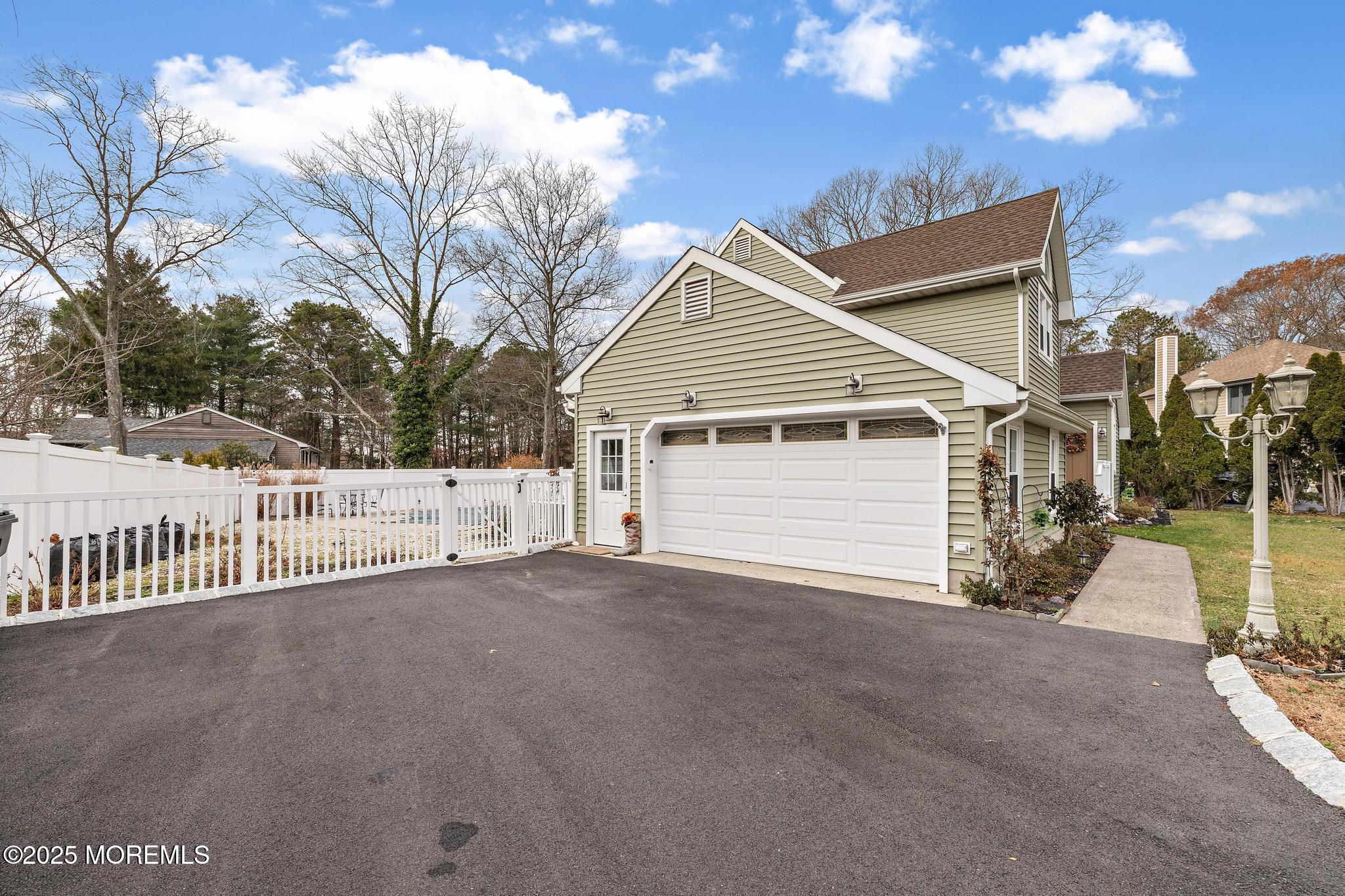 69 Chestnut Court Brick, NJ 08723 - Photo 22 of 23 a view of a house with a yard and garage
