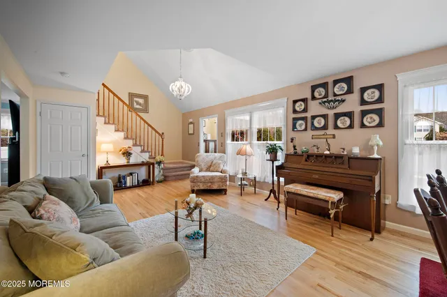 a living room with furniture a rug and a window