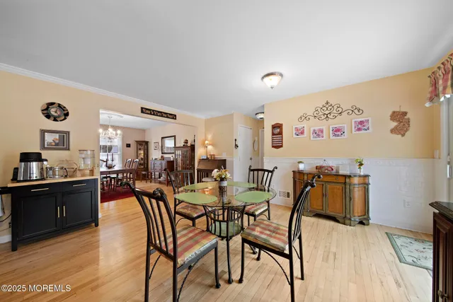 a dining room with furniture and wooden floor