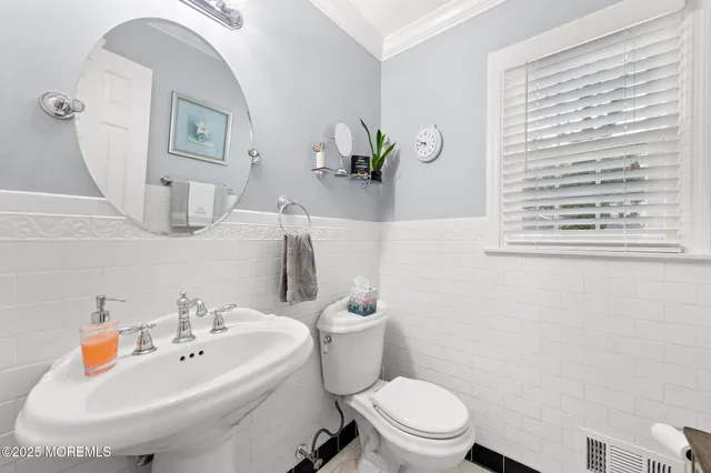 a white toilet sitting next to a bathroom sink