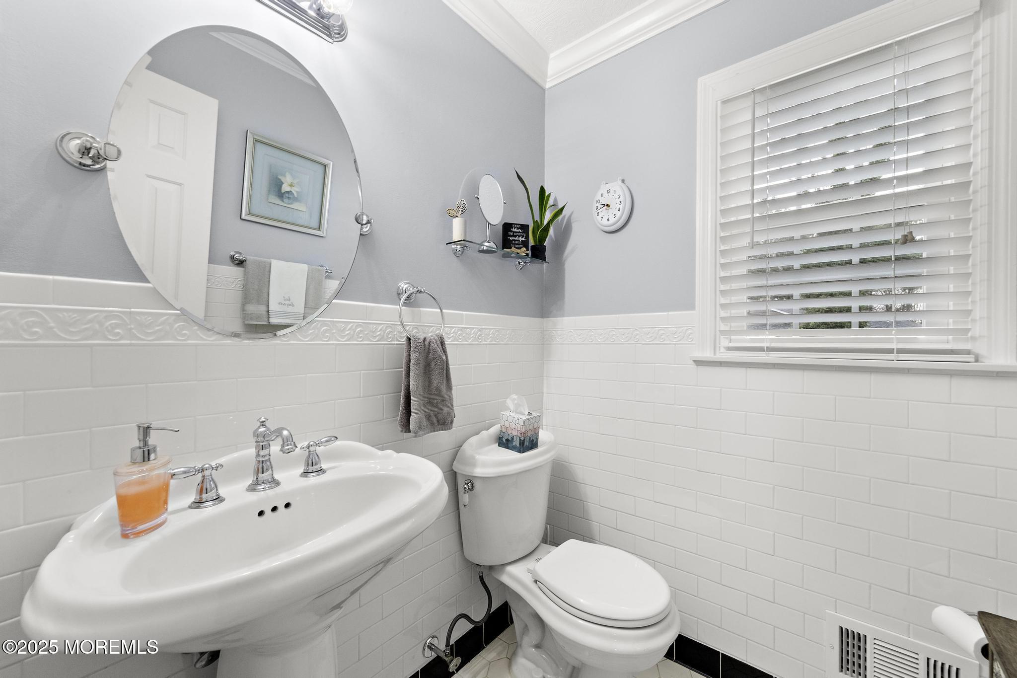 69 Chestnut Court Brick, NJ 08723 - Photo 9 of 23 a white toilet sitting next to a bathroom sink