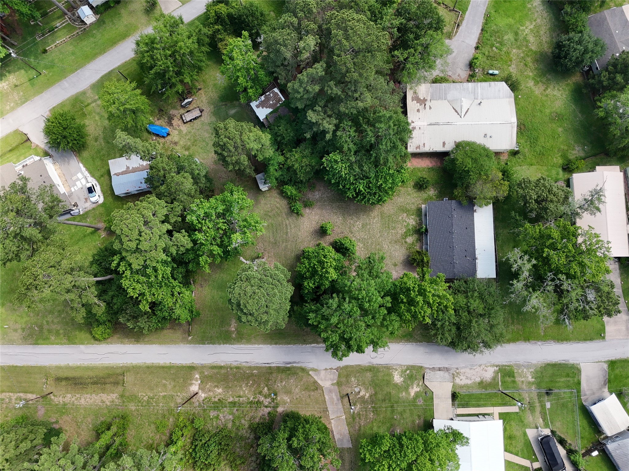 an aerial view of a house with garden space and street view