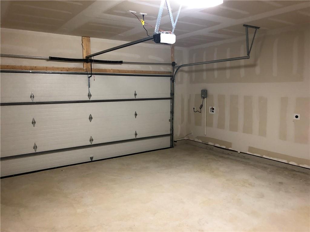 625 Jud Allen Way Leander, TX 78641 - Photo 14 of 18 Garage featuring a garage door opener