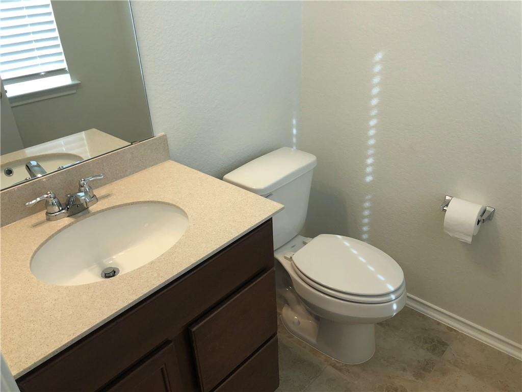 625 Jud Allen Way Leander, TX 78641 - Photo 3 of 18 Half bathroom with vanity and a textured wall