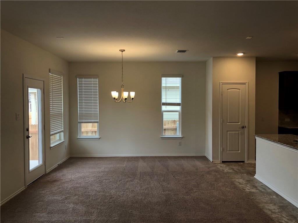 625 Jud Allen Way Leander, TX 78641 - Photo 8 of 18 Unfurnished dining area featuring dark carpet and suspended lighting