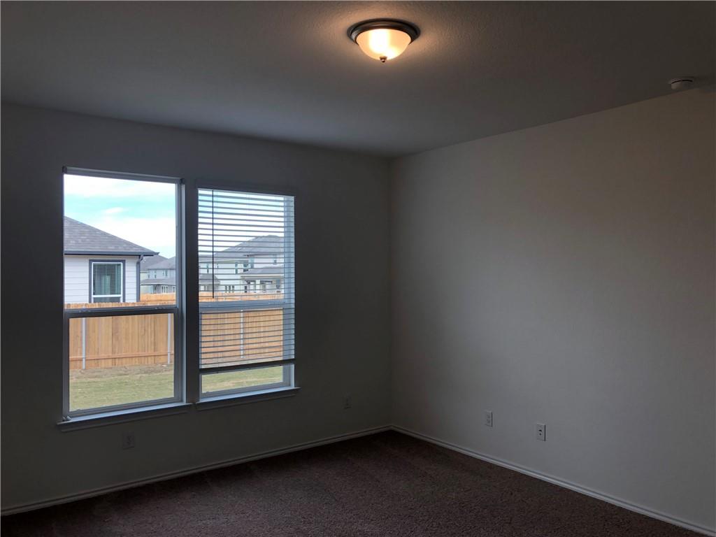 625 Jud Allen Way Leander, TX 78641 - Photo 10 of 18 Spare room featuring dark colored carpet and baseboards