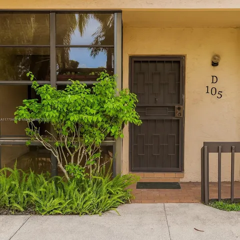 a couple of potted plants in front of door