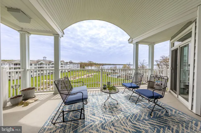 a living room with furniture and floor to ceiling windows