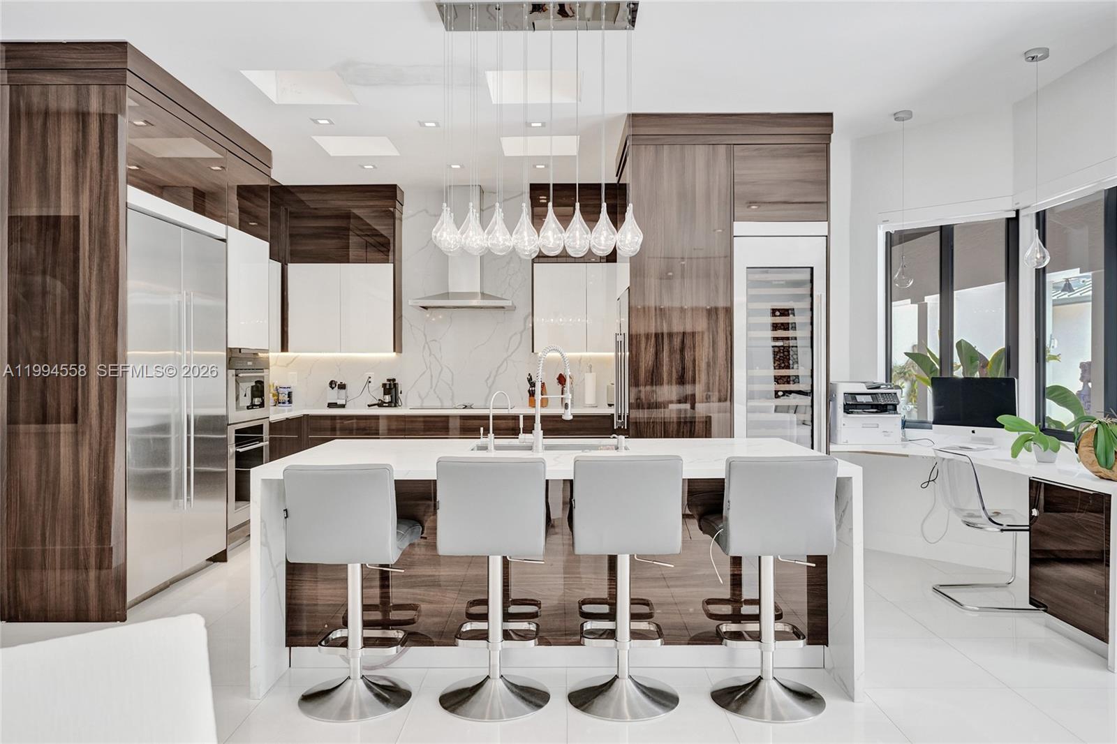 2600 Southwest 128th Court Miami, FL 33175 - Photo 13 of 50 a kitchen with a white cabinets and chairs