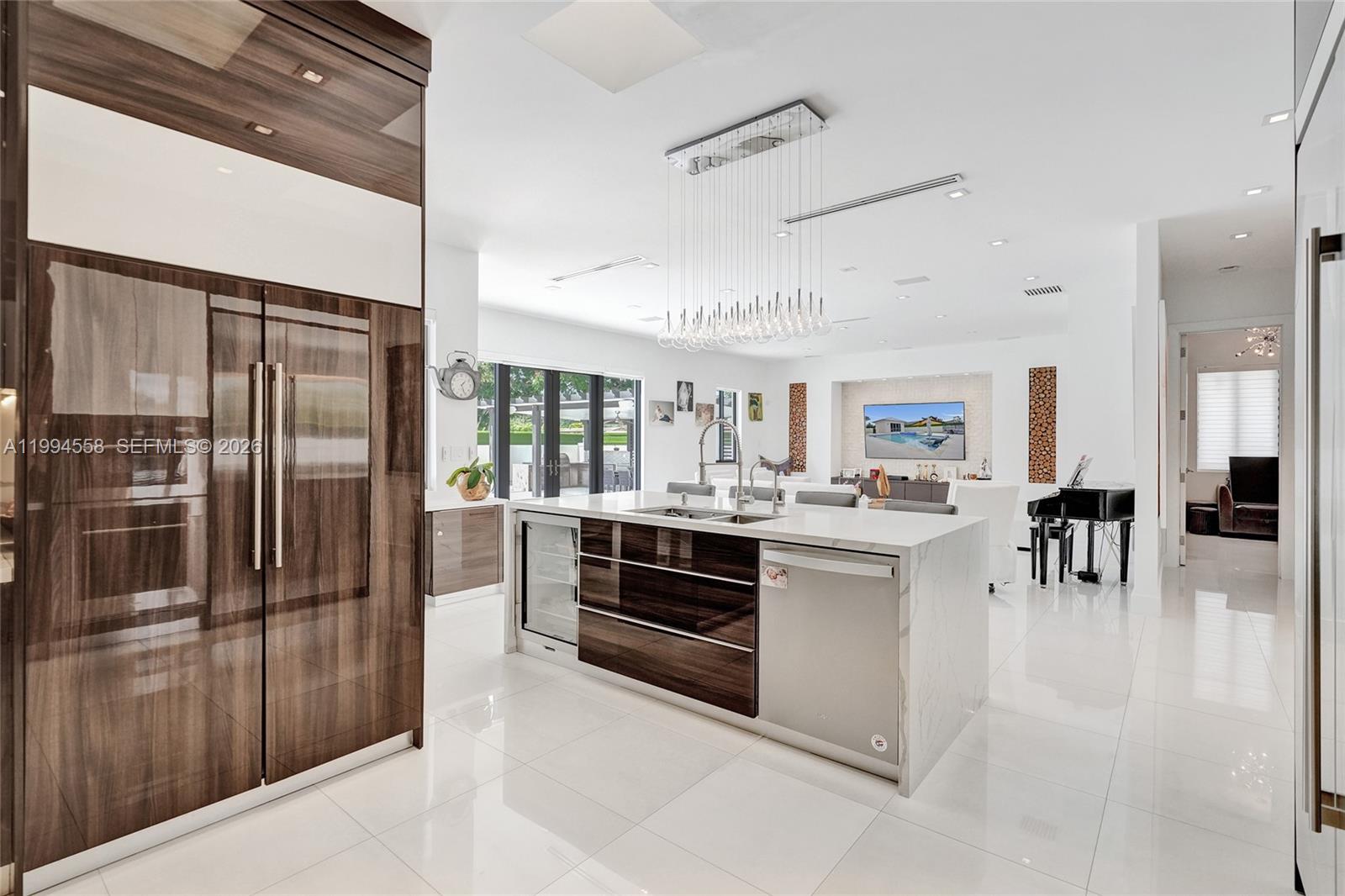 2600 Southwest 128th Court Miami, FL 33175 - Photo 17 of 50 a kitchen with stainless steel appliances kitchen island granite countertop a refrigerator and a stove top oven