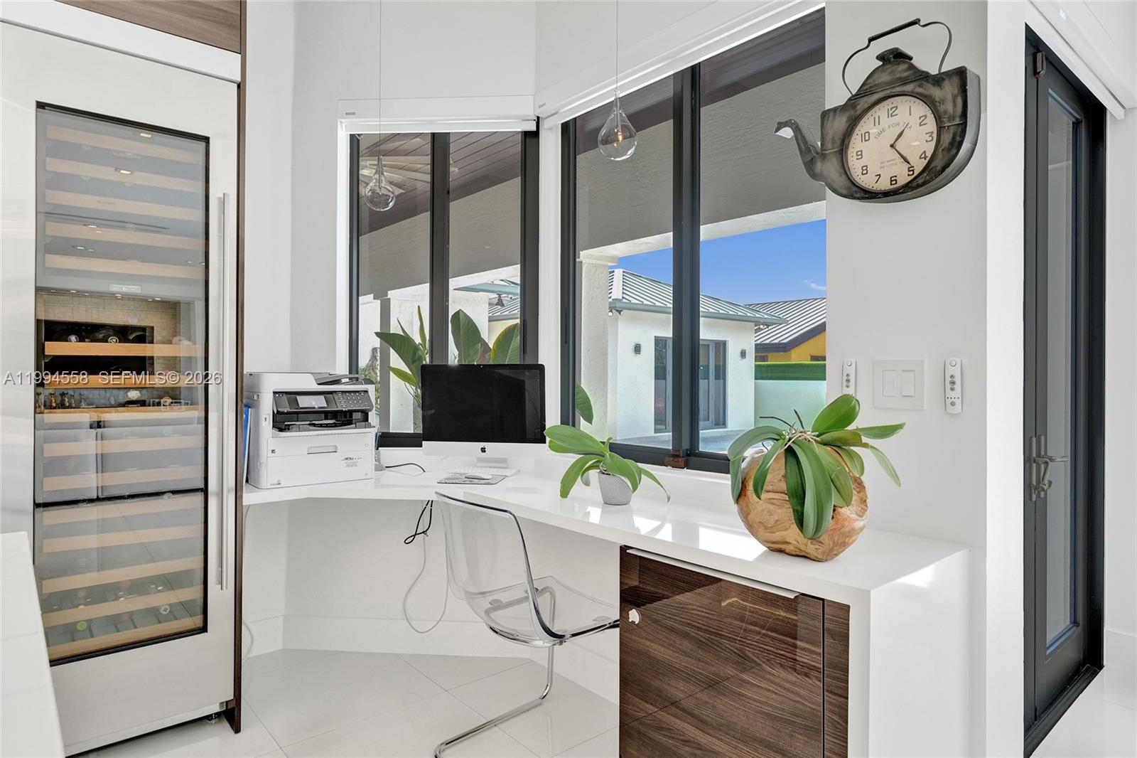 2600 Southwest 128th Court Miami, FL 33175 - Photo 18 of 50 a work place with a desk a clock and a window