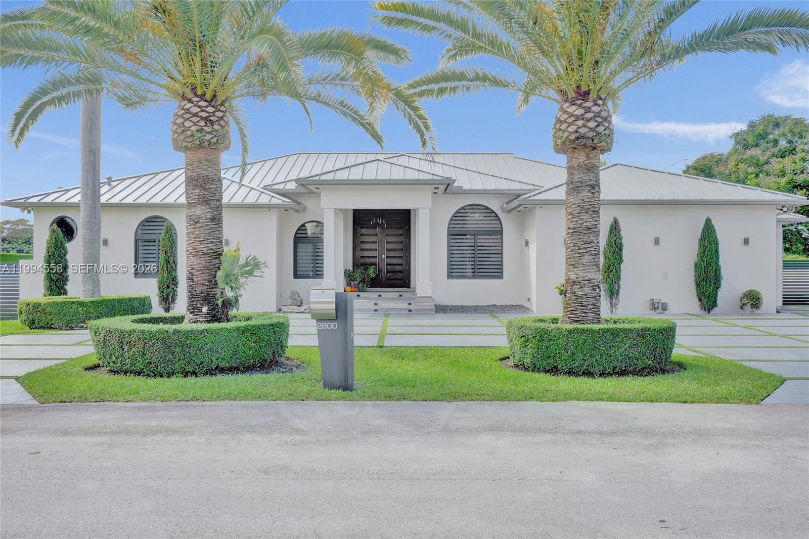 2600 Southwest 128th Court Miami, FL 33175 - Photo 2 of 50 a front view of a house with a garden and plants