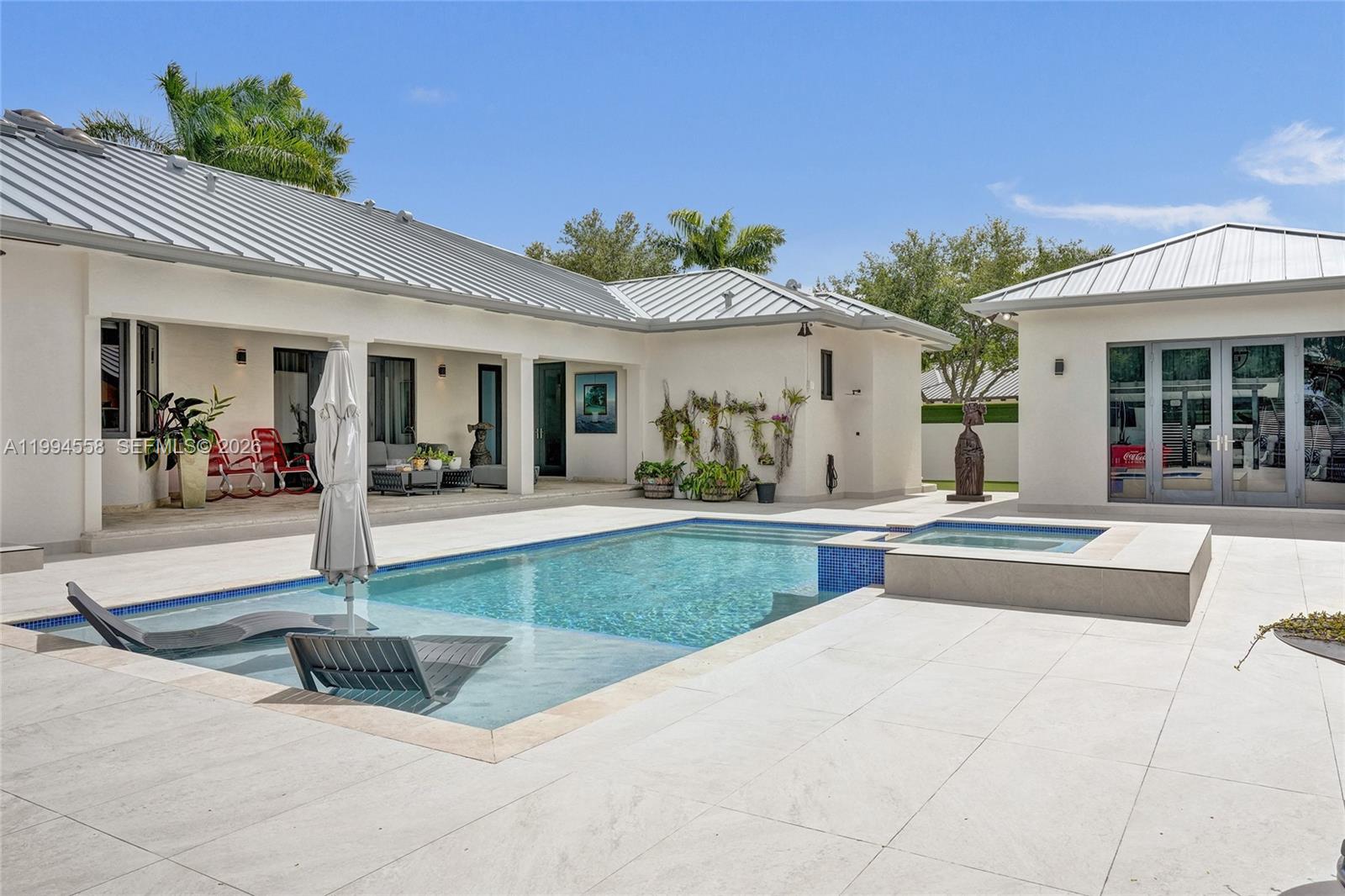 2600 Southwest 128th Court Miami, FL 33175 - Photo 22 of 50 a view of a house with potted plants and a table and chairs
