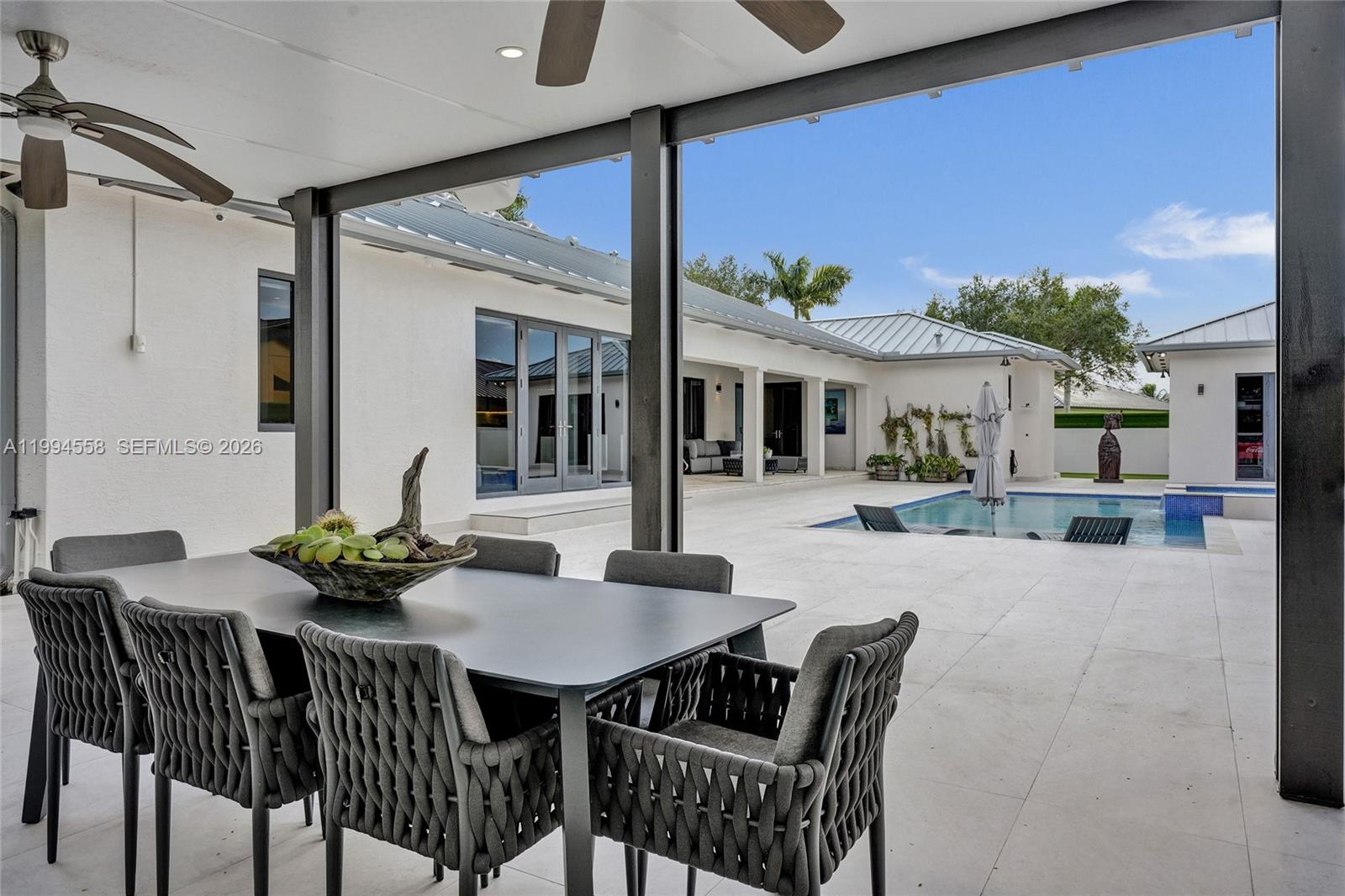 2600 Southwest 128th Court Miami, FL 33175 - Photo 25 of 50 a view of a patio with a table and chairs