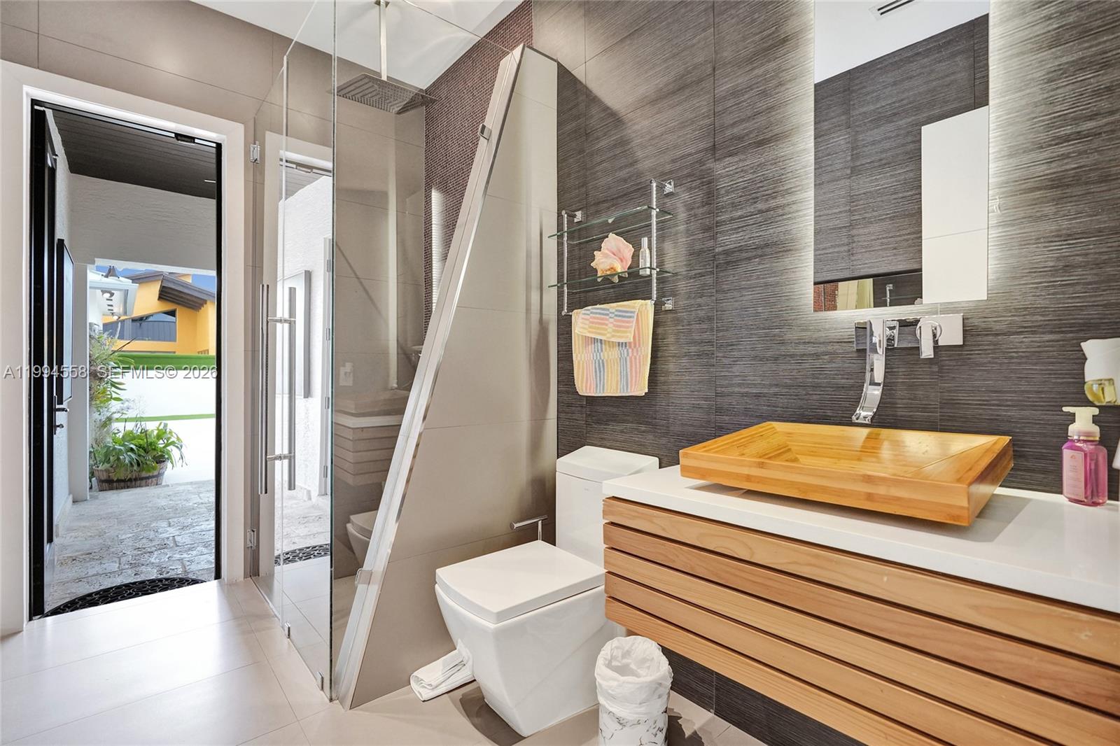 2600 Southwest 128th Court Miami, FL 33175 - Photo 29 of 50 a bathroom with a sink a toilet a mirror and shower