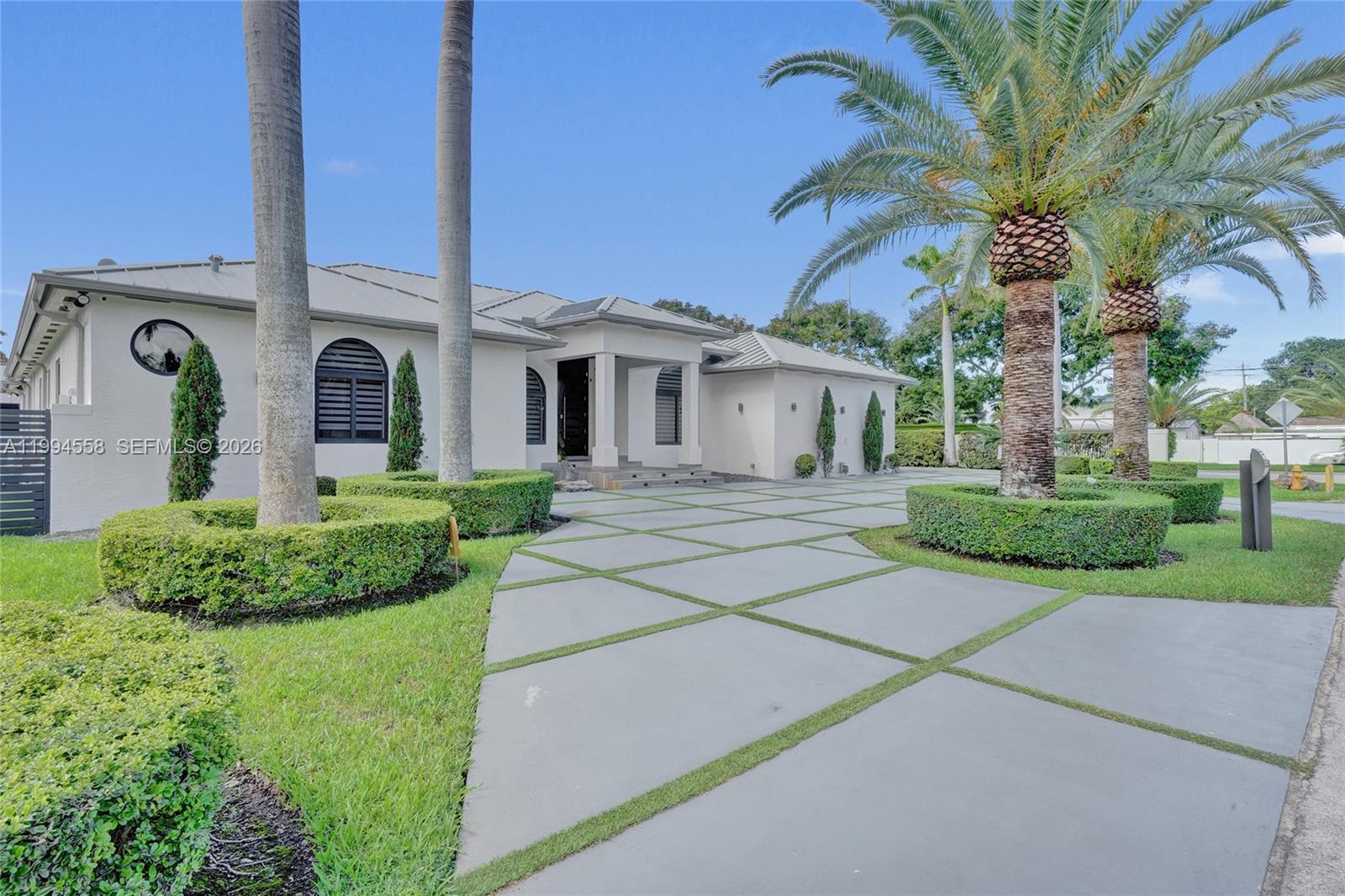 2600 Southwest 128th Court Miami, FL 33175 - Photo 3 of 50 a front view of a house with a garden