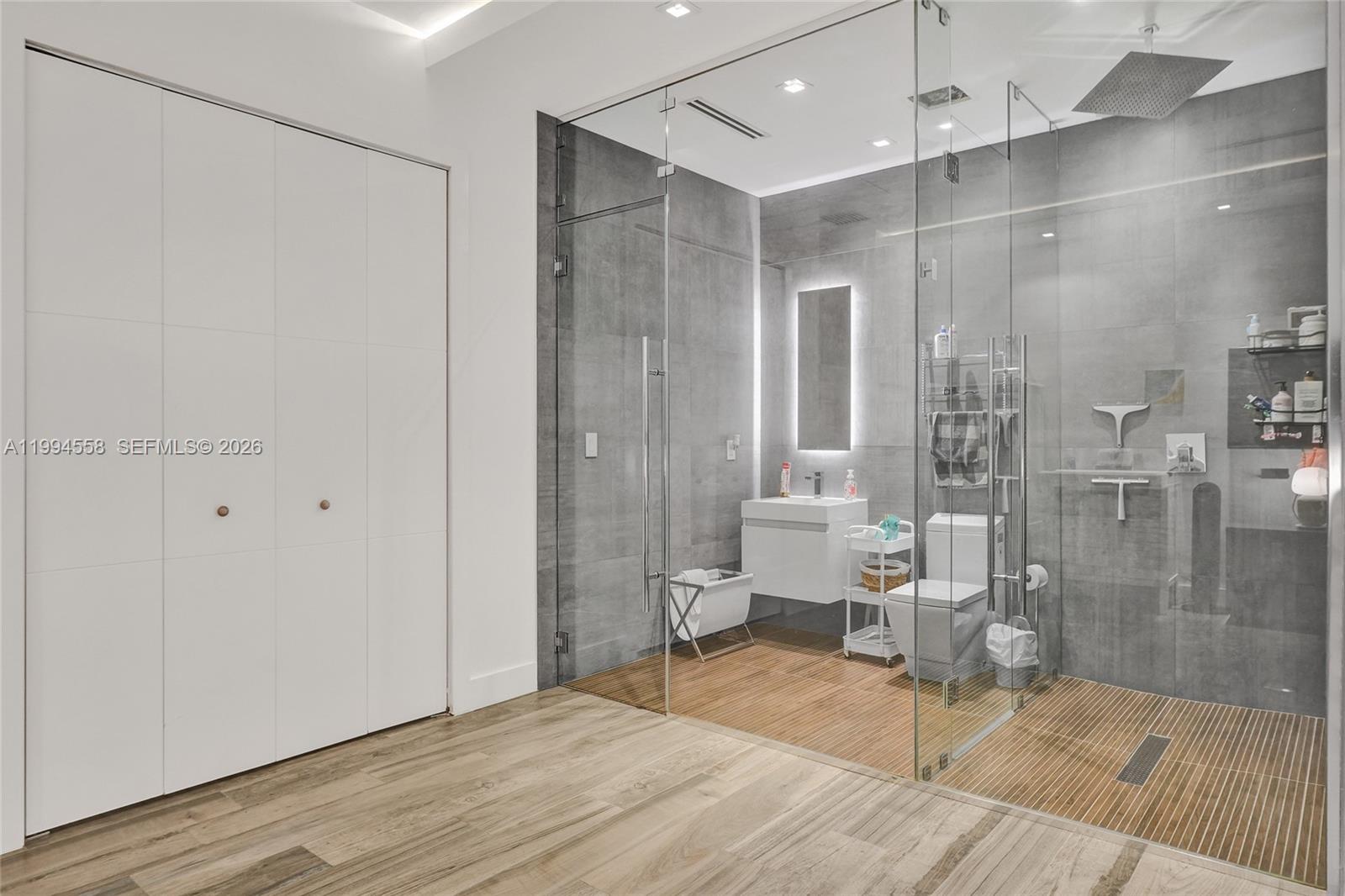 2600 Southwest 128th Court Miami, FL 33175 - Photo 43 of 50 a spacious bathroom with a glass shower door and a toilet