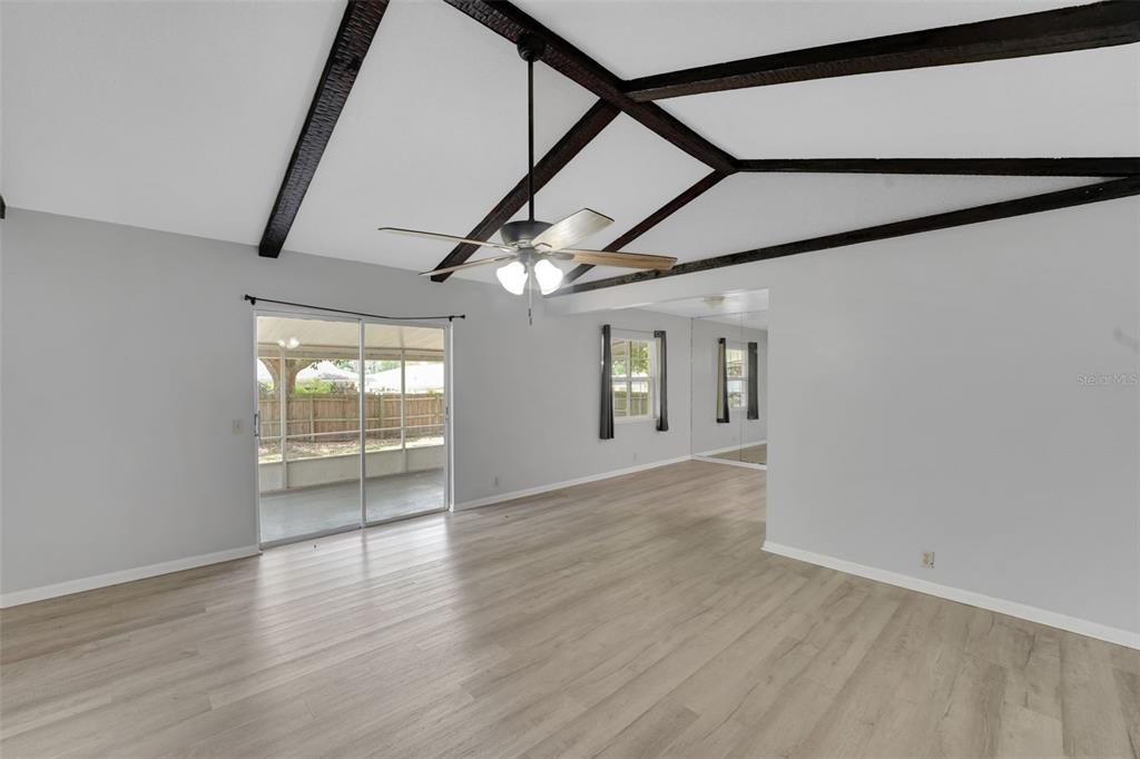 404 Lake Ned Road Winter Haven, FL 33884 - Photo 6 of 18 an empty room with wooden floor and windows