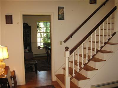1323 County Road Cataumet, MA 02534 - Photo 3 of 22 a view of entryway with wooden floor and stairs
