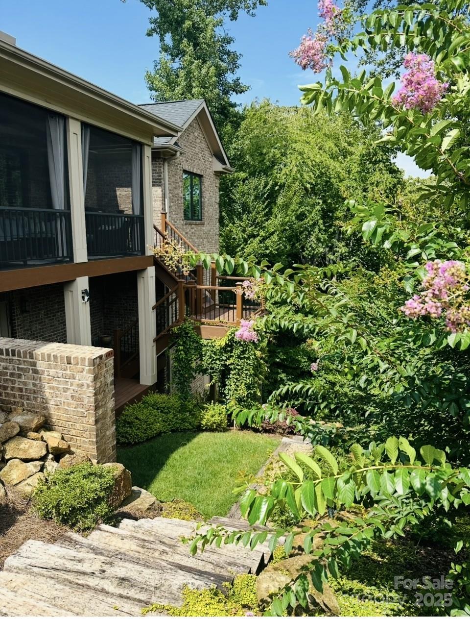101 Silver Trce Lane, Unit 101 Denver, NC 28037 - Photo 10 of 10 a view of a house with brick walls and flower plants