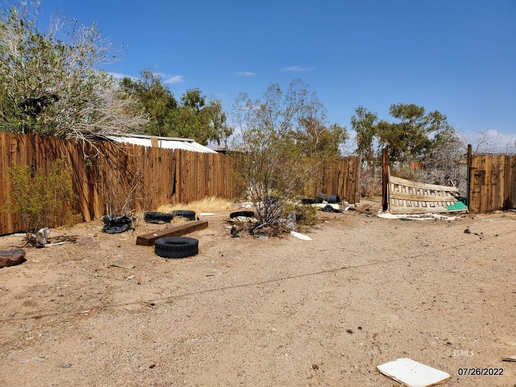 1745 West Upjohn Avenue Ridgecrest, CA 93555 - Photo 24 of 26 a view of a backyard with a tree