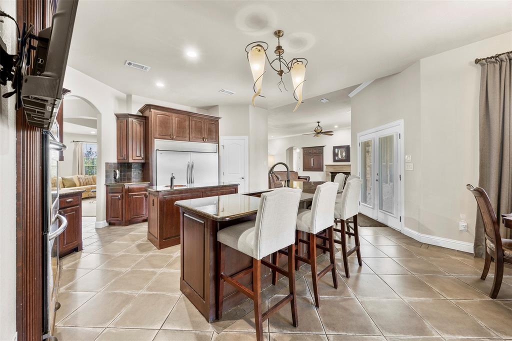 219 Mohundro Road Ferris, TX 75125 - Photo 9 of 40 a view of a dining room with furniture and a chandelier