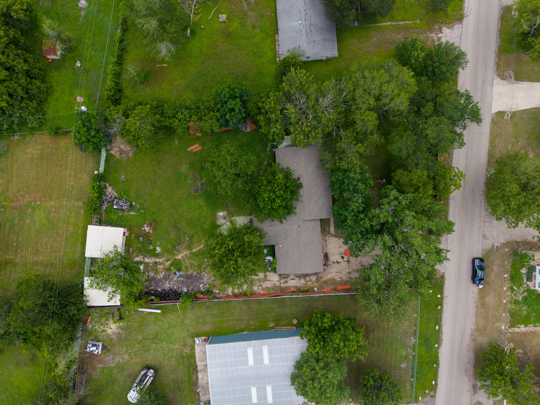 6803 Viewing Place Austin, TX 78719 - Photo 8 of 20 An aerial perspective reveals a vast lot with a modest structure nestled amongst mature trees, offering ample potential.