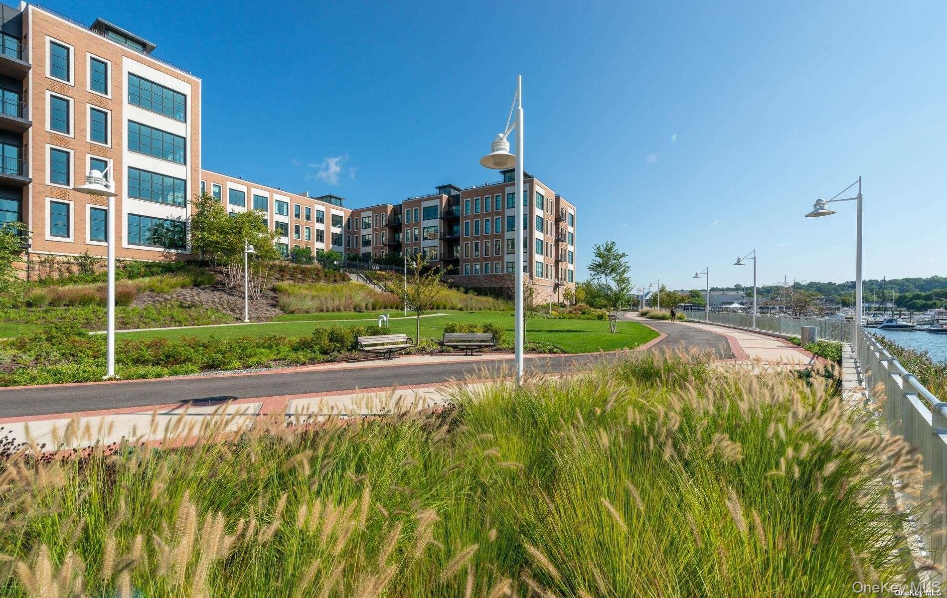 100 Garvies Point Road, Unit 1014 Glen Cove, NY 11542 - Photo 14 of 27 a view of a garden with a building in the background