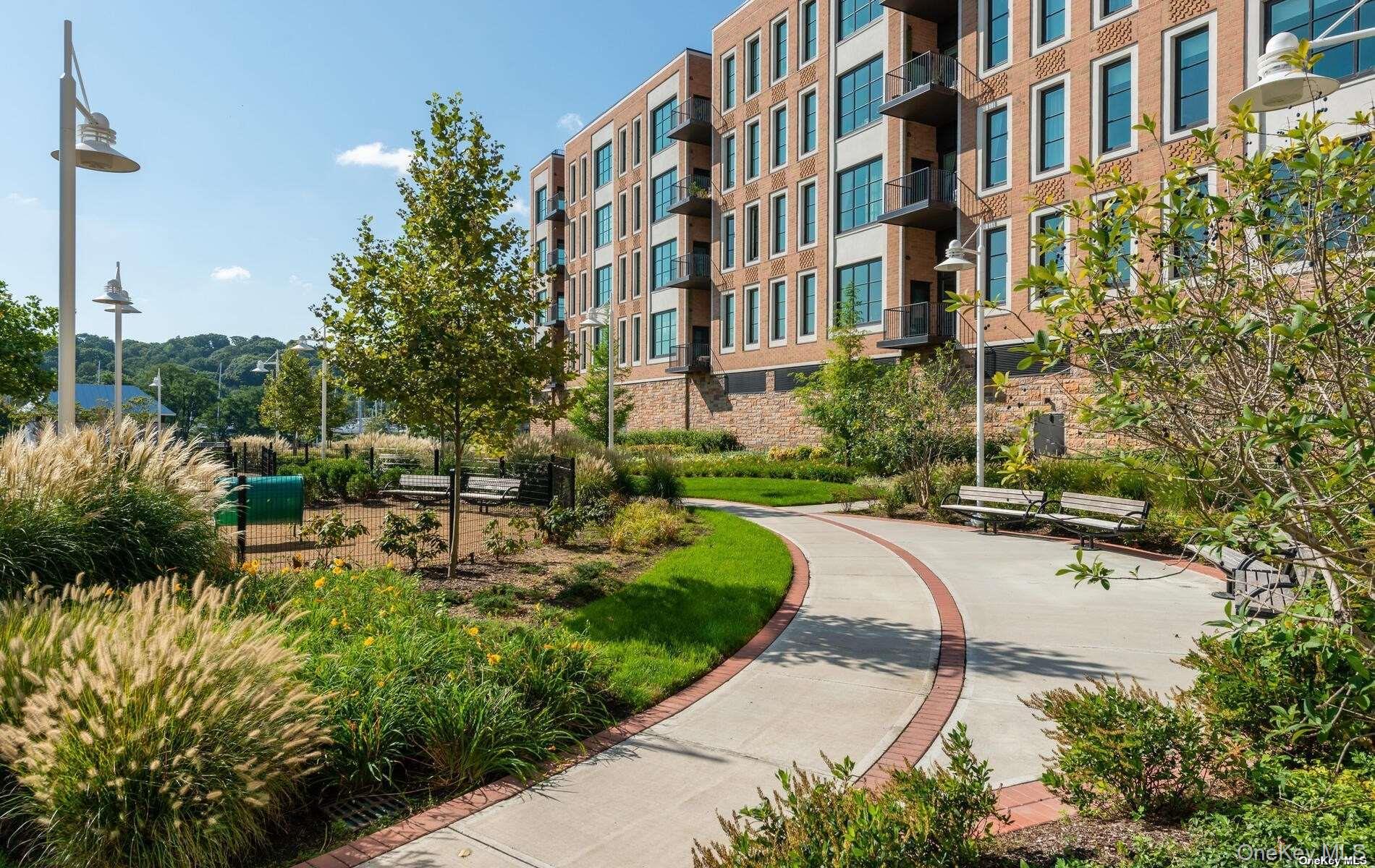 100 Garvies Point Road, Unit 1014 Glen Cove, NY 11542 - Photo 15 of 27 a view of a building with garden and pathway