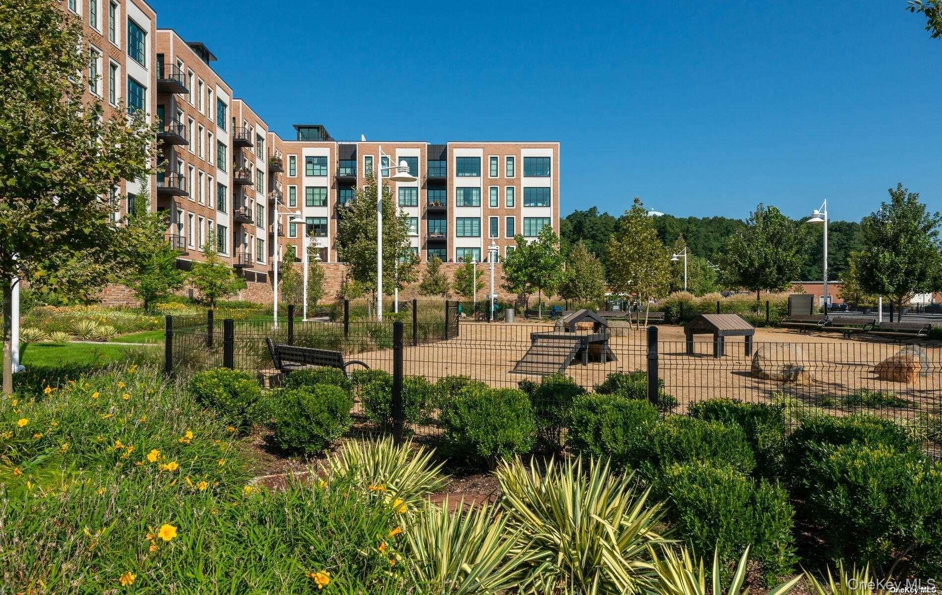 100 Garvies Point Road, Unit 1014 Glen Cove, NY 11542 - Photo 16 of 27 a swimming pool with outdoor seating and yard