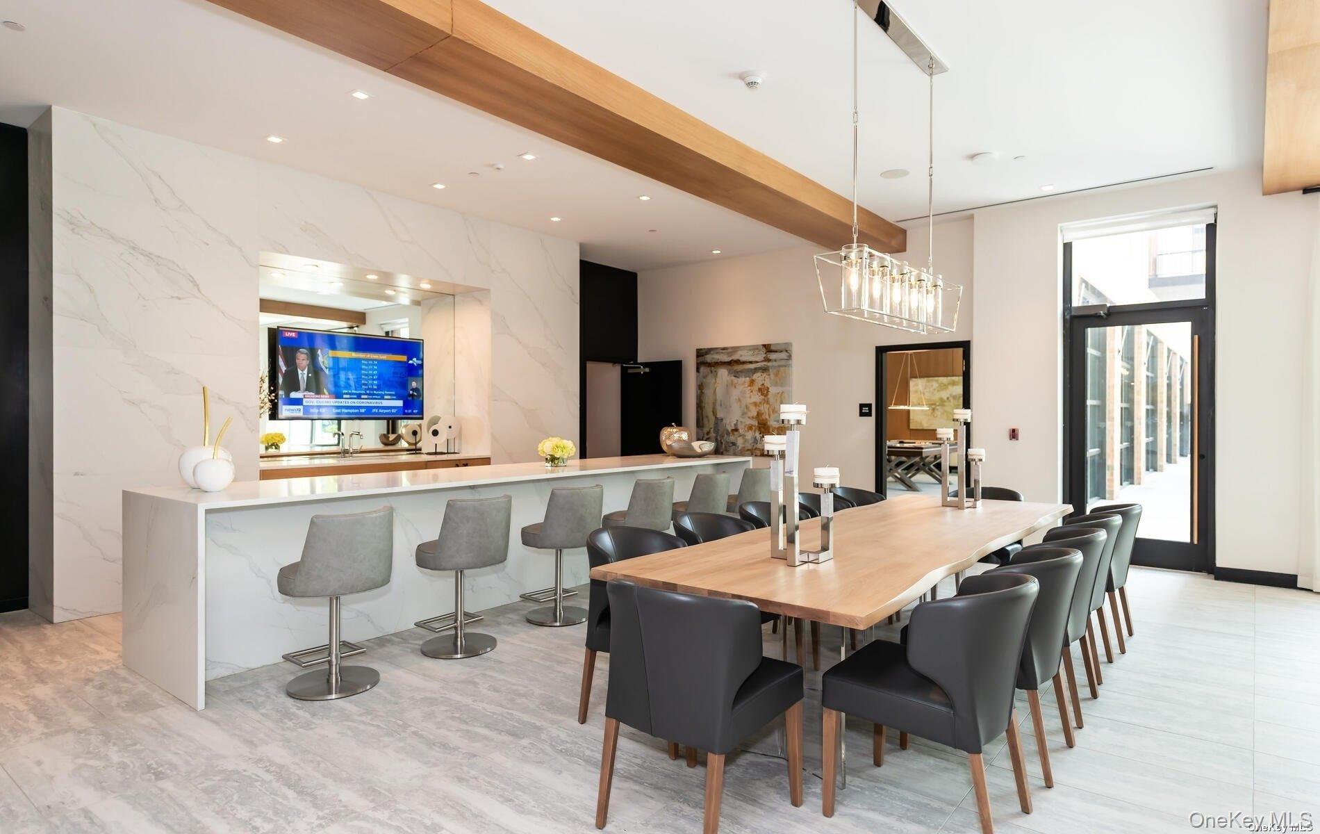 100 Garvies Point Road, Unit 1014 Glen Cove, NY 11542 - Photo 20 of 27 a view of a dining room with furniture window and wooden floor