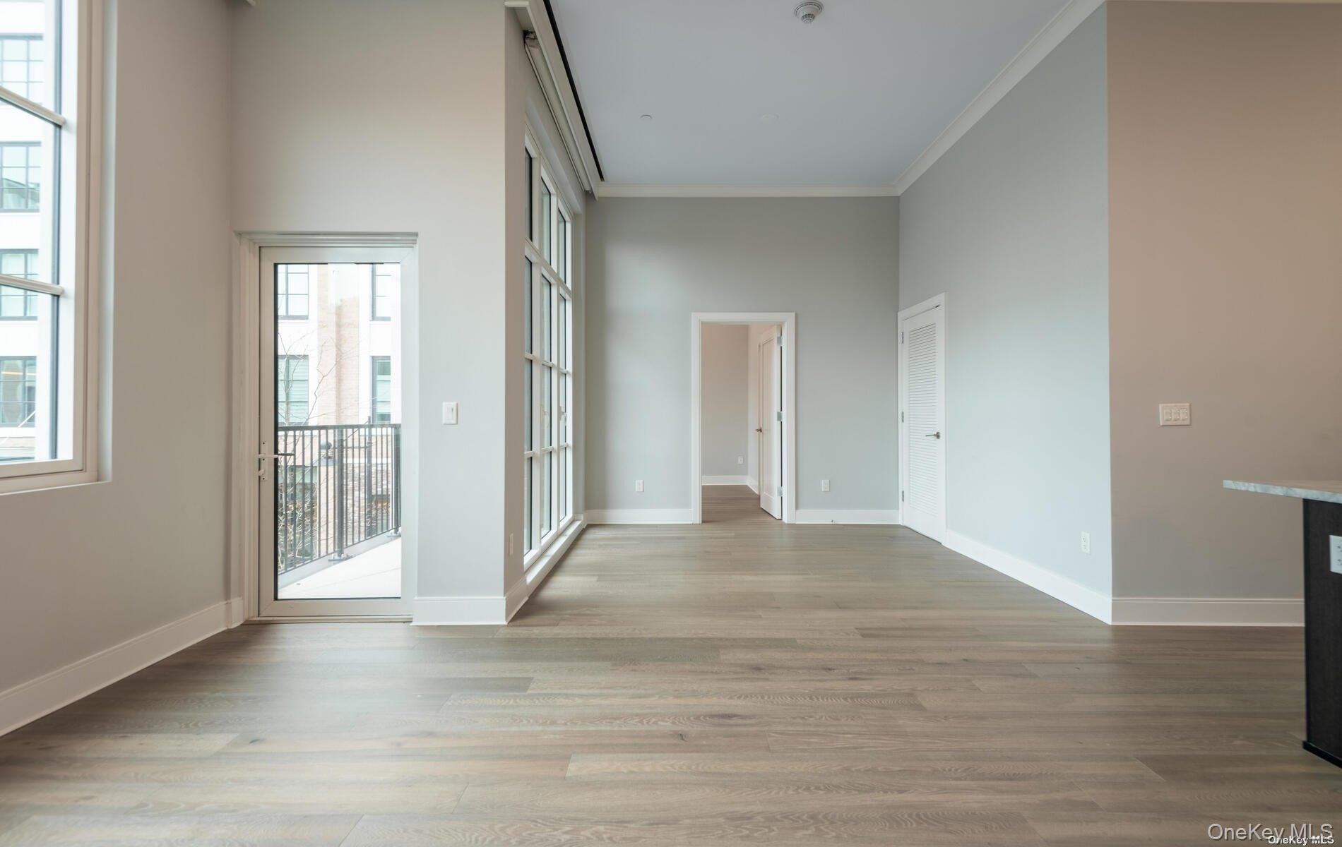 100 Garvies Point Road, Unit 1014 Glen Cove, NY 11542 - Photo 2 of 27 a view of entryway with wooden floor