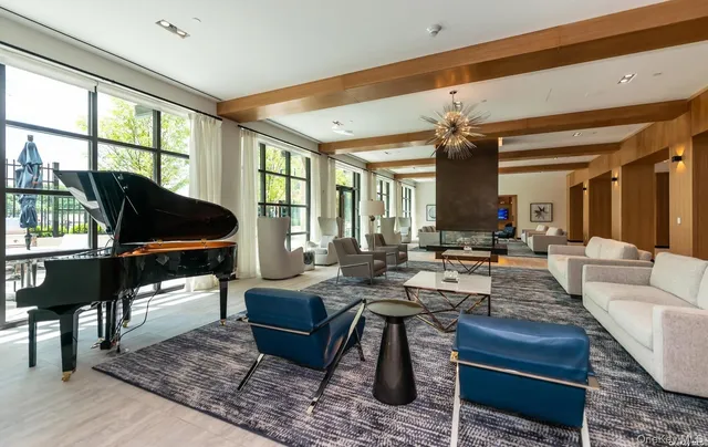 a living room with furniture a rug and a large window