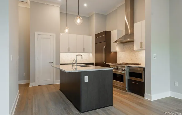 a kitchen with stainless steel appliances granite countertop a stove and a refrigerator