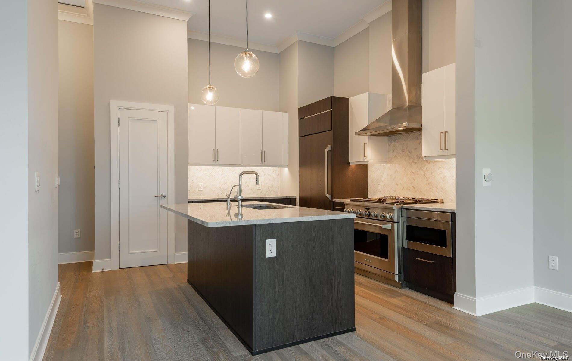 100 Garvies Point Road, Unit 1014 Glen Cove, NY 11542 - Photo 6 of 27 a kitchen with stainless steel appliances granite countertop a stove and a refrigerator