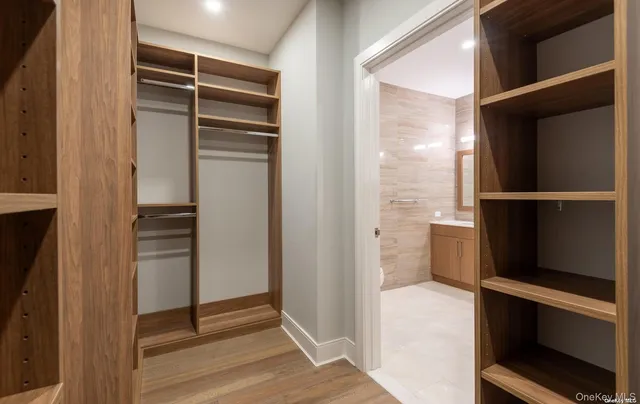 a view of walk in closet with empty racks