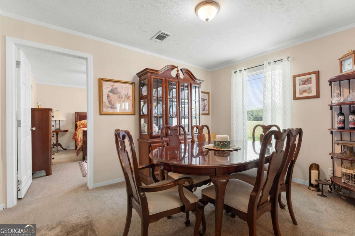 3516 Bennetts Landing Road Millen, GA 30442 - Photo 13 of 34 a view of a dining room with furniture and window