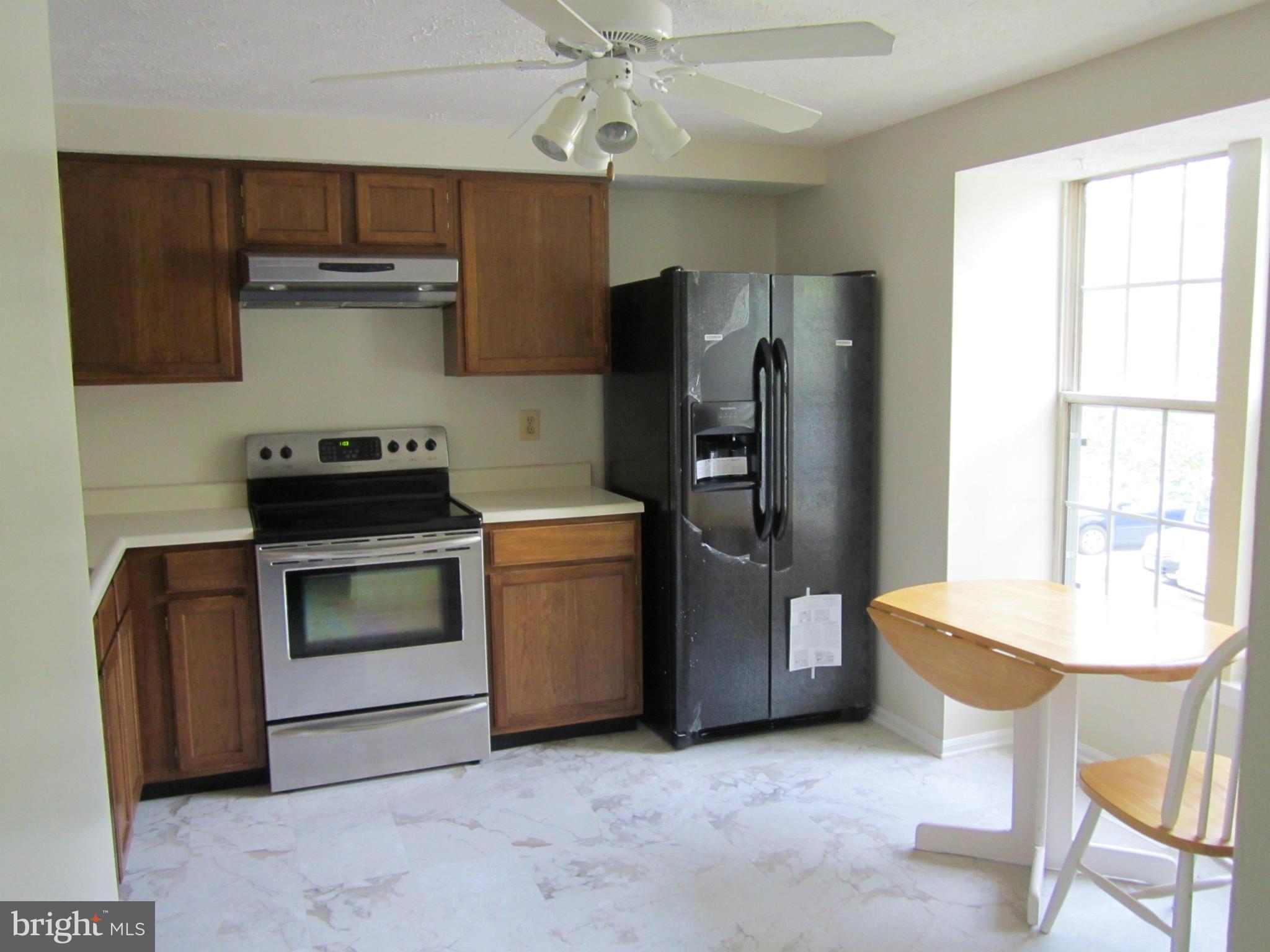 5021 Clifford Road Perry Hall, MD 21128 - Photo 3 of 15 a kitchen with stainless steel appliances a stove a refrigerator and a table